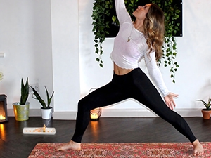 A woman burns sacred wood in a sacred wood rest while doing yoga.